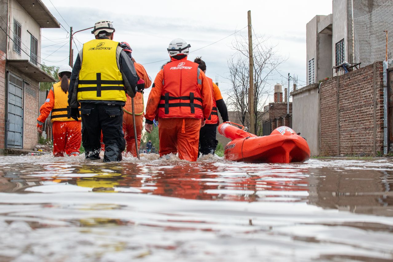 Emergency responders navigate floodwaters during a disaster response, highlighting the need for emergency language services and language access.