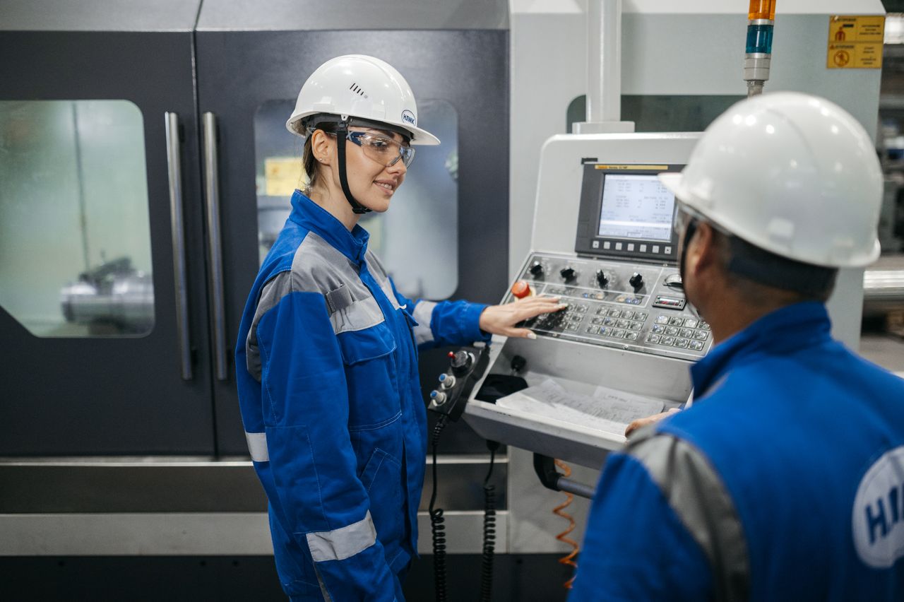 Engineers operating industrial machinery during Factory Acceptance Testing with professional interpretation supporting multilingual technical communication.