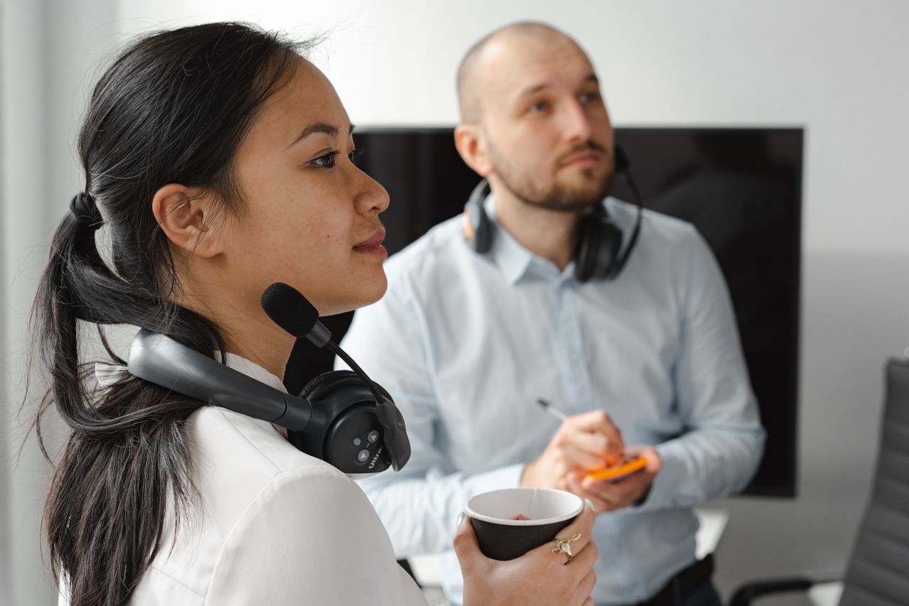 Healthcare interpreters using headsets during a medical interpreting session, illustrating VRI and on-site interpreting services.